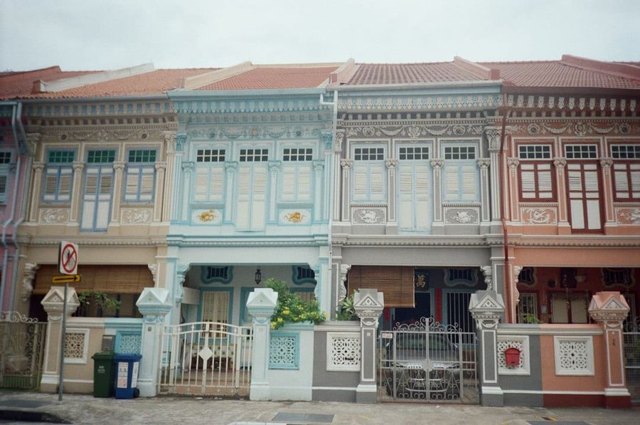 Row of colourful traditional shophouses with ornate facades