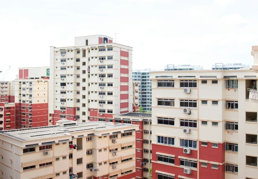 White concrete HDB buildings under white clouds